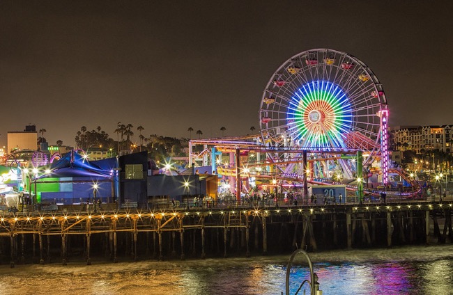 Ferris wheel and Pacific Park on Santa Monica Pier lit up at night